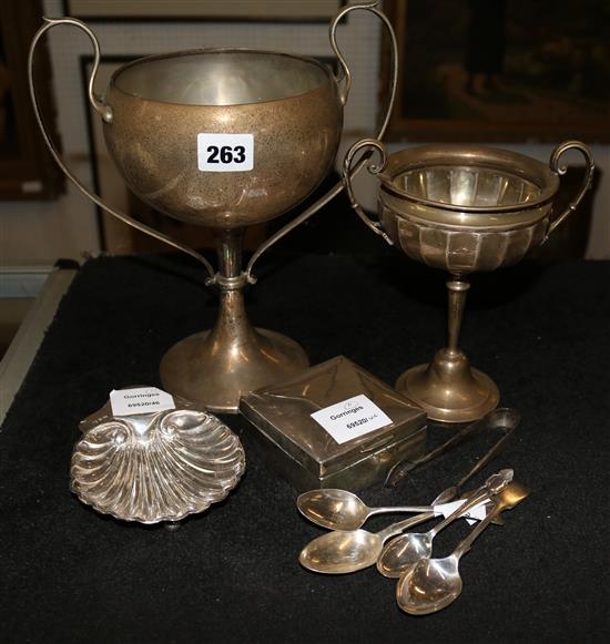 Silver:. A butter shell, 2 two handled trophy cups, a cigarette box and 3 spoons (10)